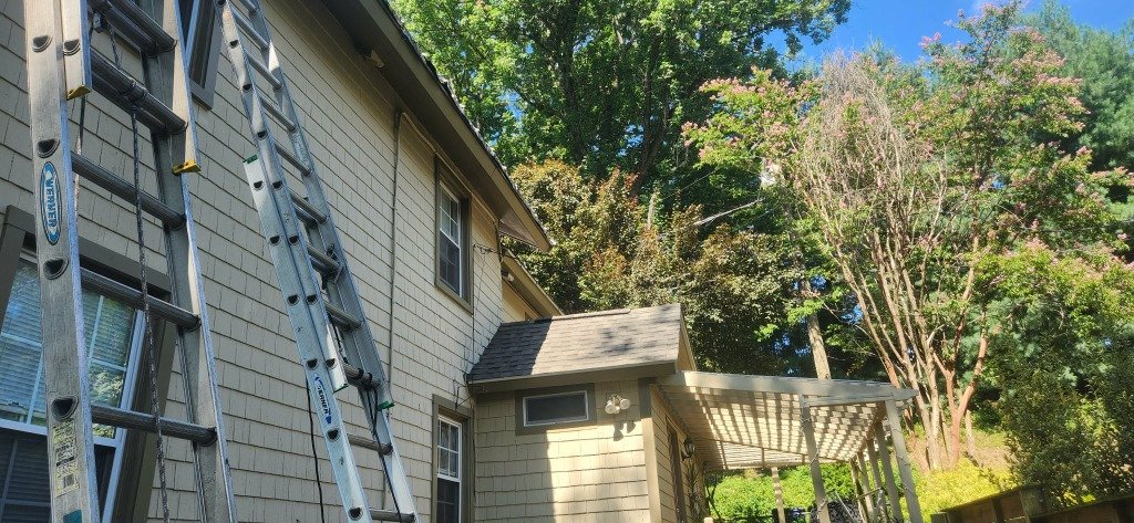 Gutters Baltimore technician installing gutters on a Baltimore home
