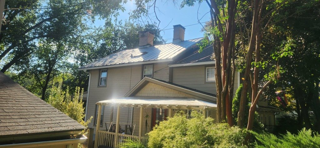 Completed gutter installation on metal roof home Baltimore