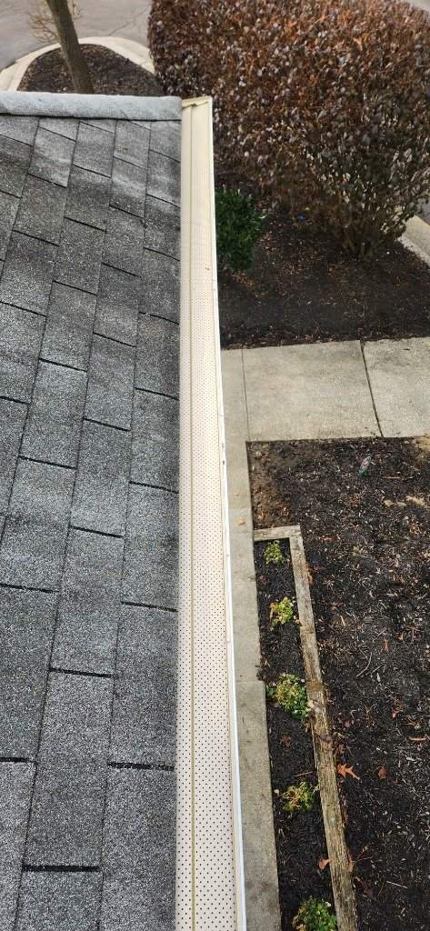 Professional gutter guards installed on a Baltimore home rooftop